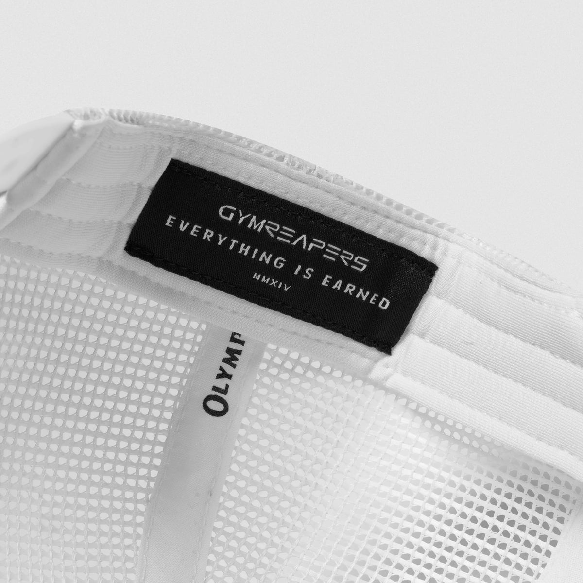 The inside tag of the Signature Foam Trucker Hat that says GYMREAPERS Everything is earned MMXIV