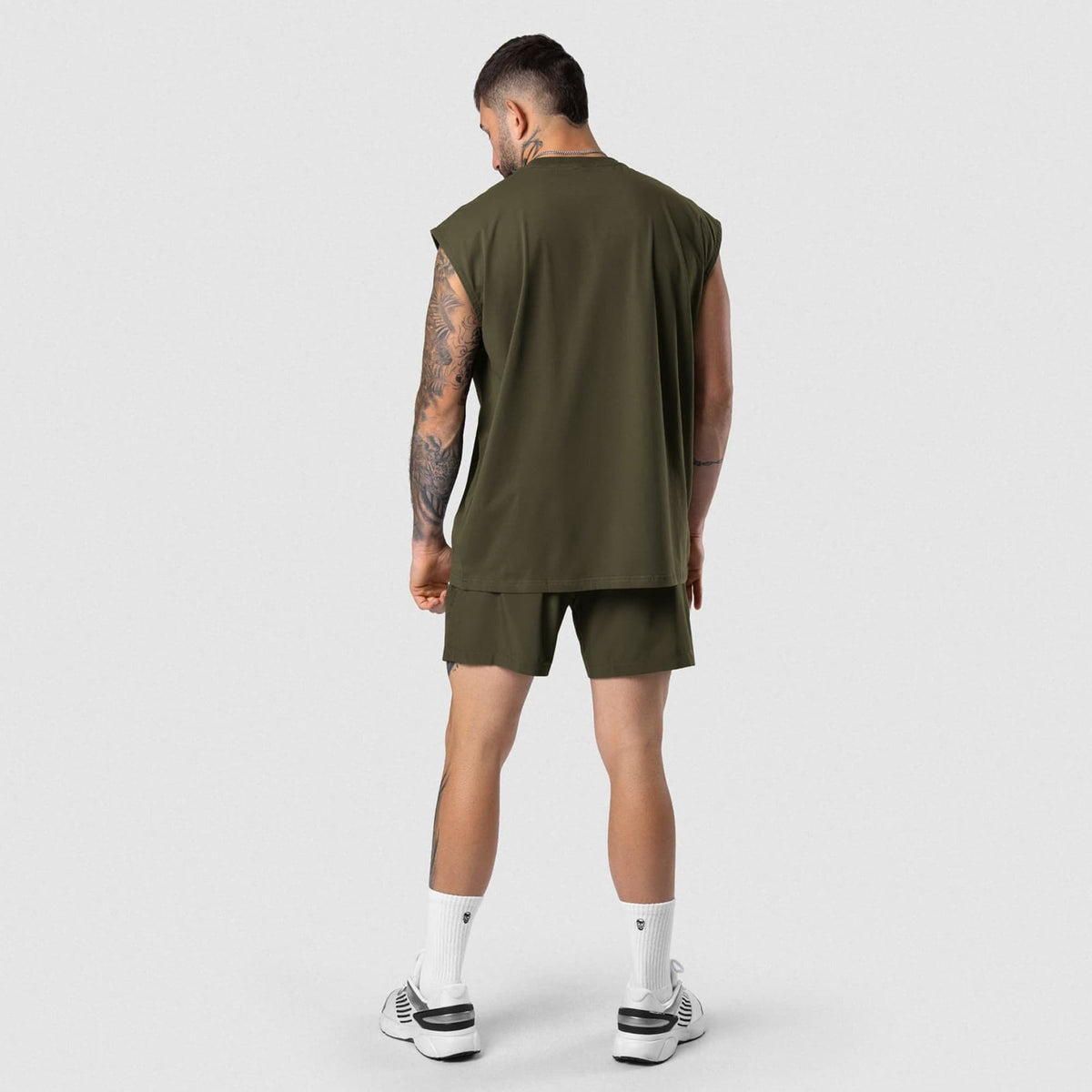 Male model wearing the Axis Cap Sleeve Tank - OD Green back view