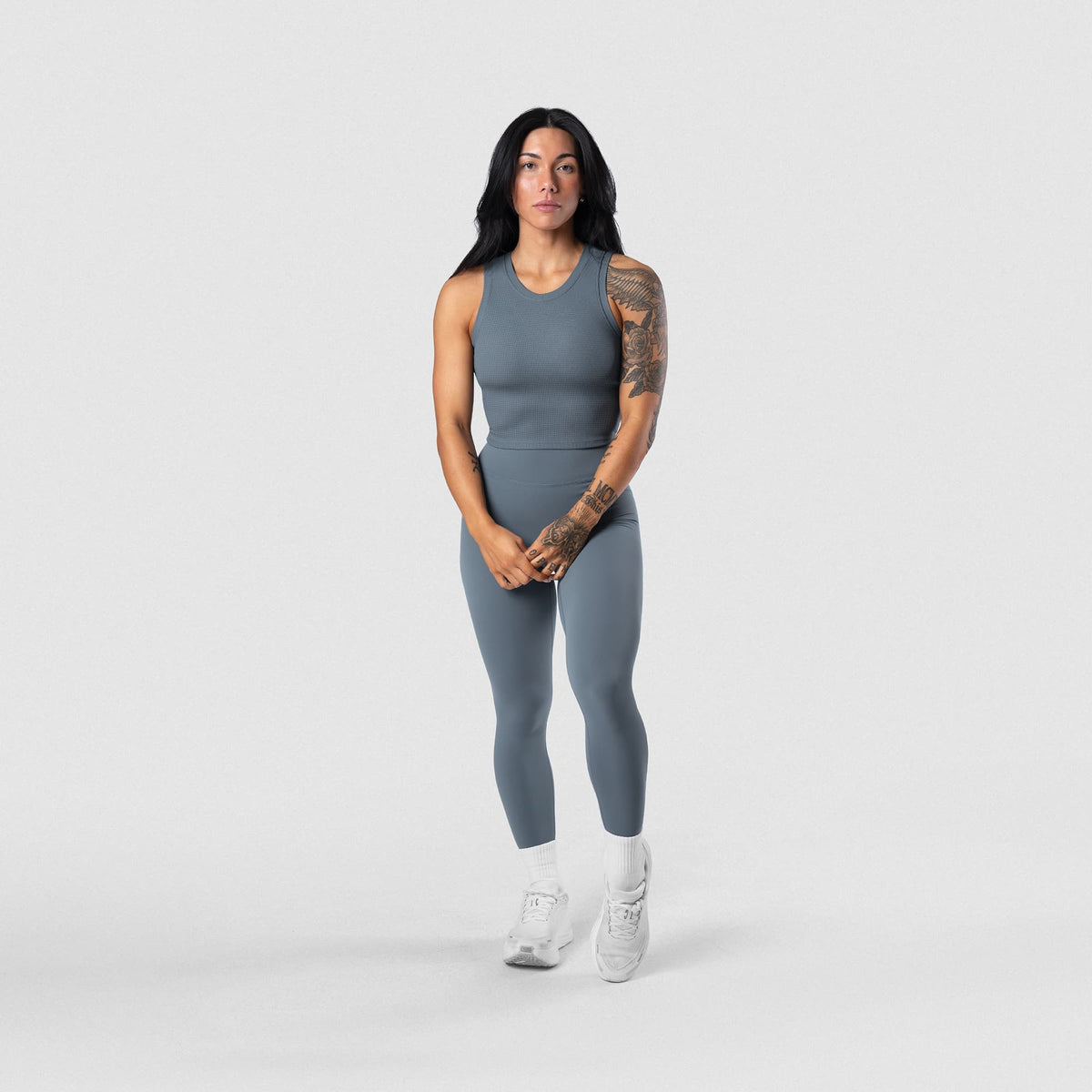 Female model wearing the Axis Leggings - Lake full-body front view