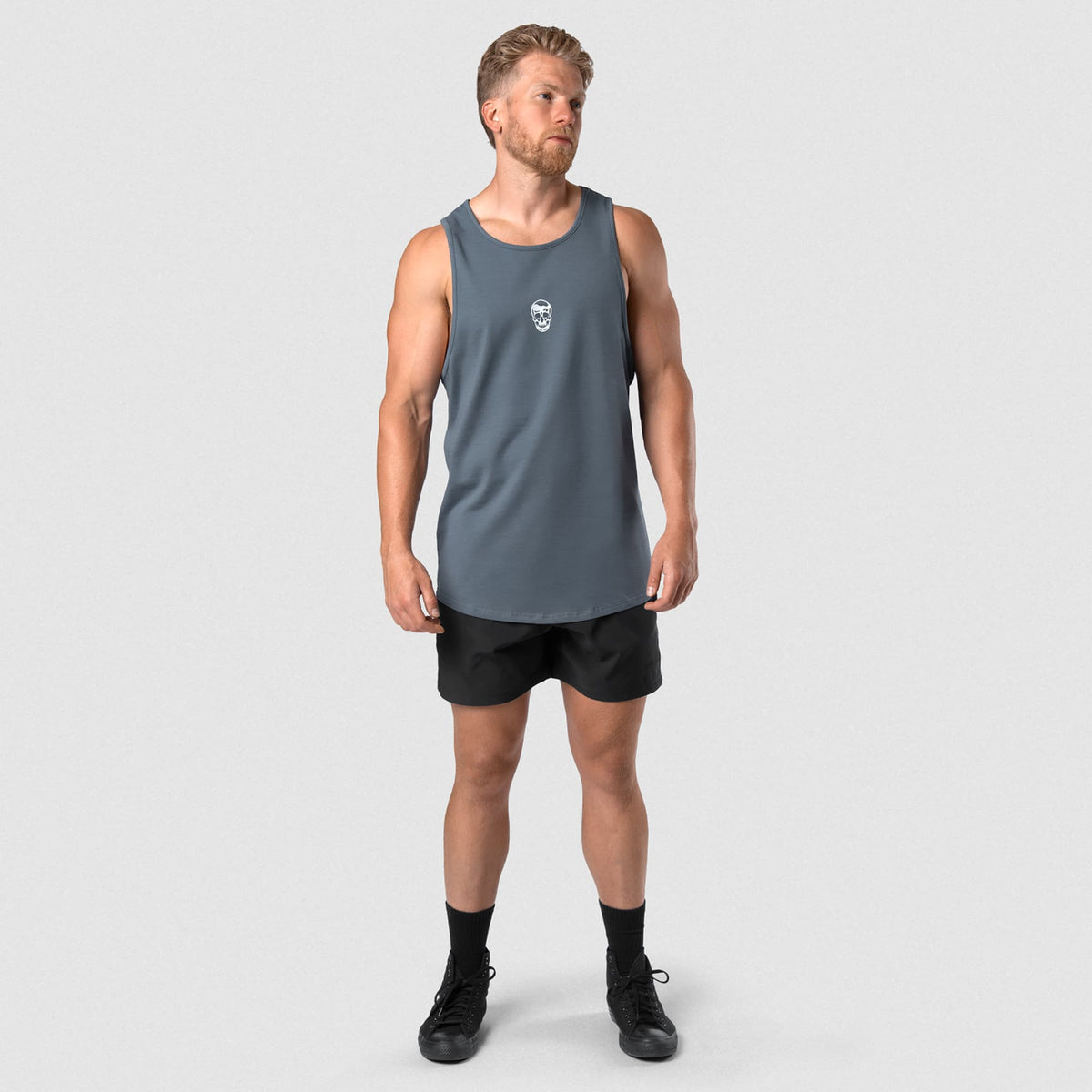 Male model wearing the Axis Scoop Hem Tank - Lake full-body view