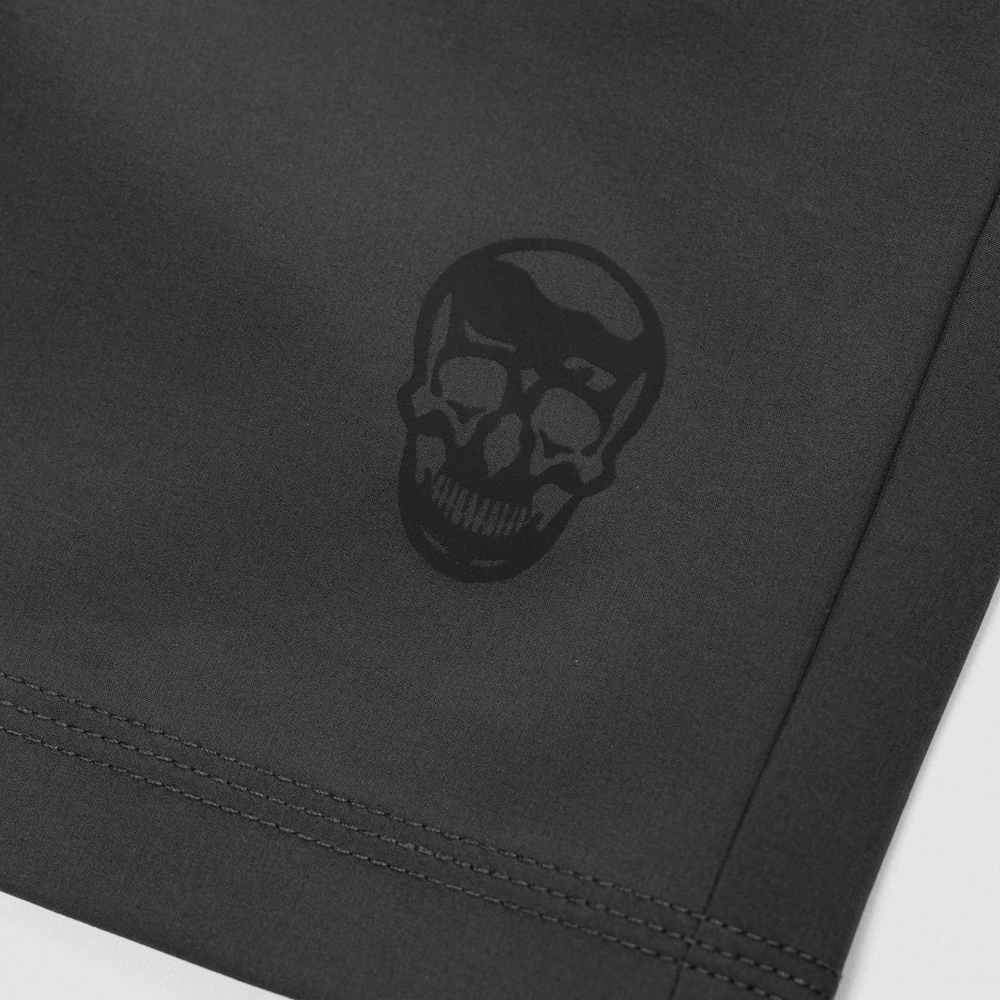 Reflective Gymreapers skull logo detail on Men's Conquer 7 Inch Shorts - Dark Gray