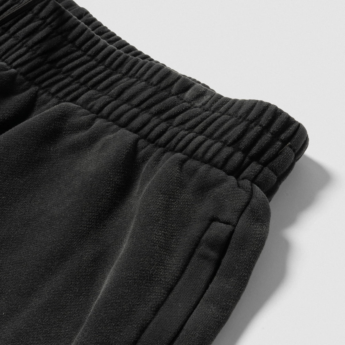 Close up view of the adjustable waistband and pocket on the black Championship Straight-Leg Jogger