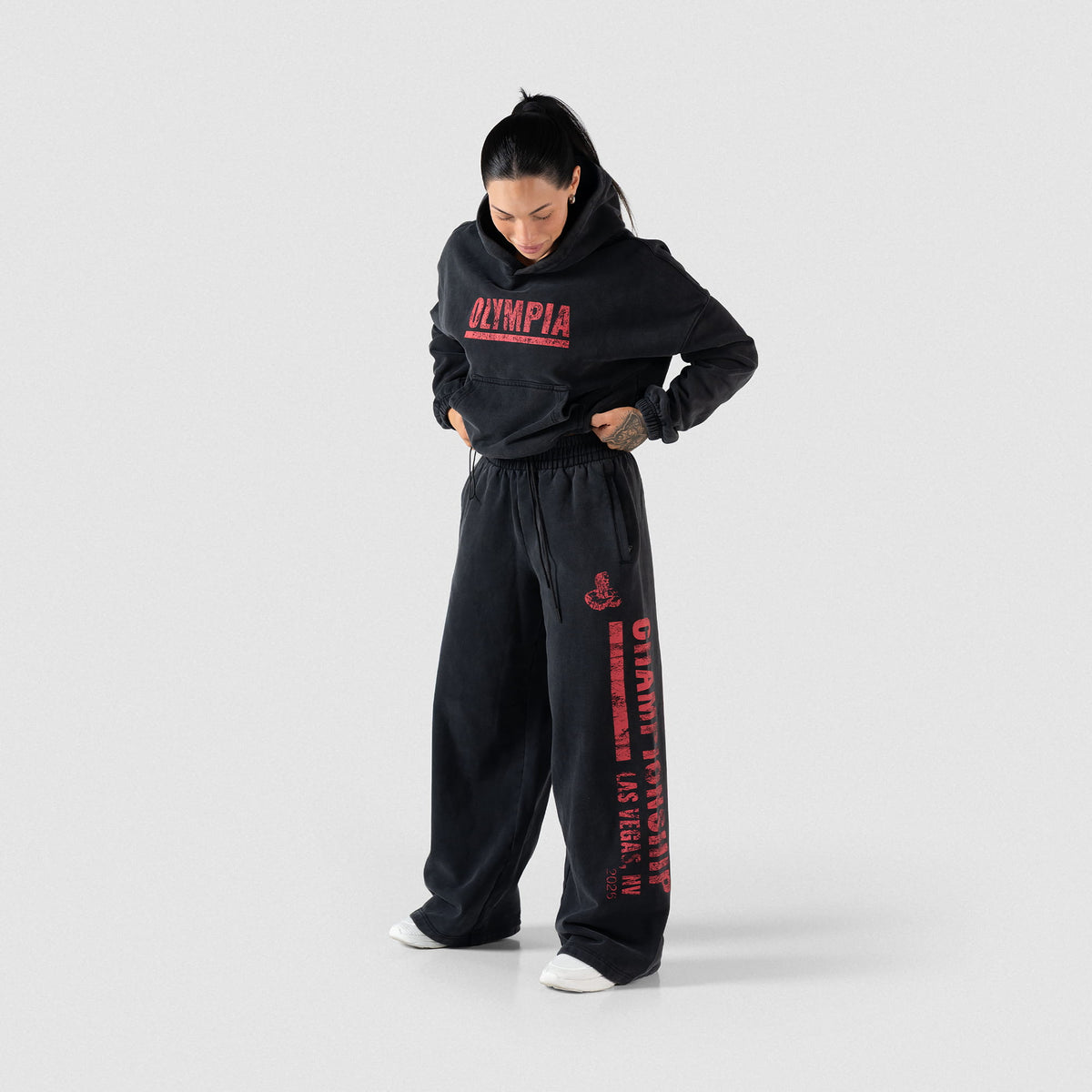 Female model wearing the Championship Wide-Leg Jogger black sweatpants paired with a black hoodie