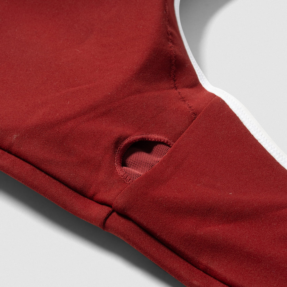 Close up of the removable pad insert hole on the inside of the Olympia High Neck Bra - Ember Red