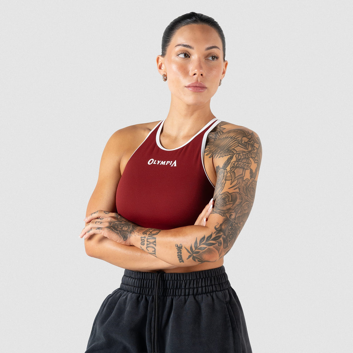 Female model wearing the red and white contrasting Olympia high neck sports bra