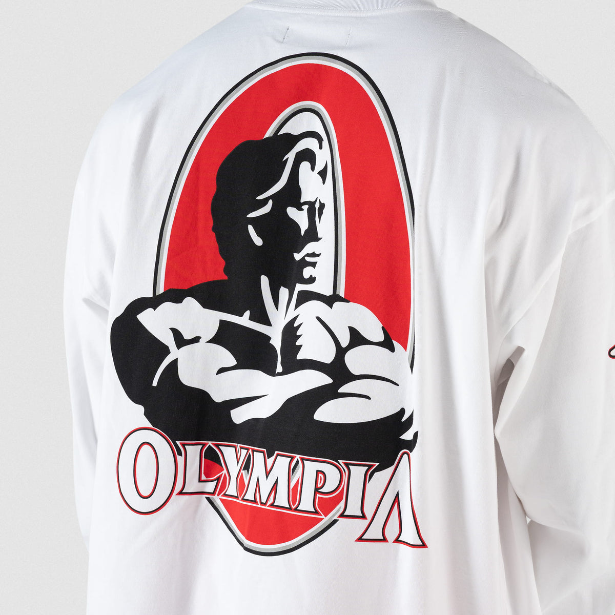 Close up of large back logo of classic Olympia bodybuilding Signature logo on the Signature Long Sleeve Tee in white