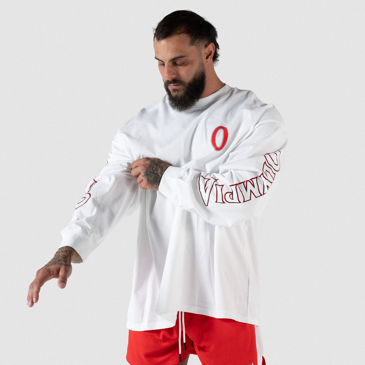 Torso view of male model wearing white Signature Long Sleeve tee