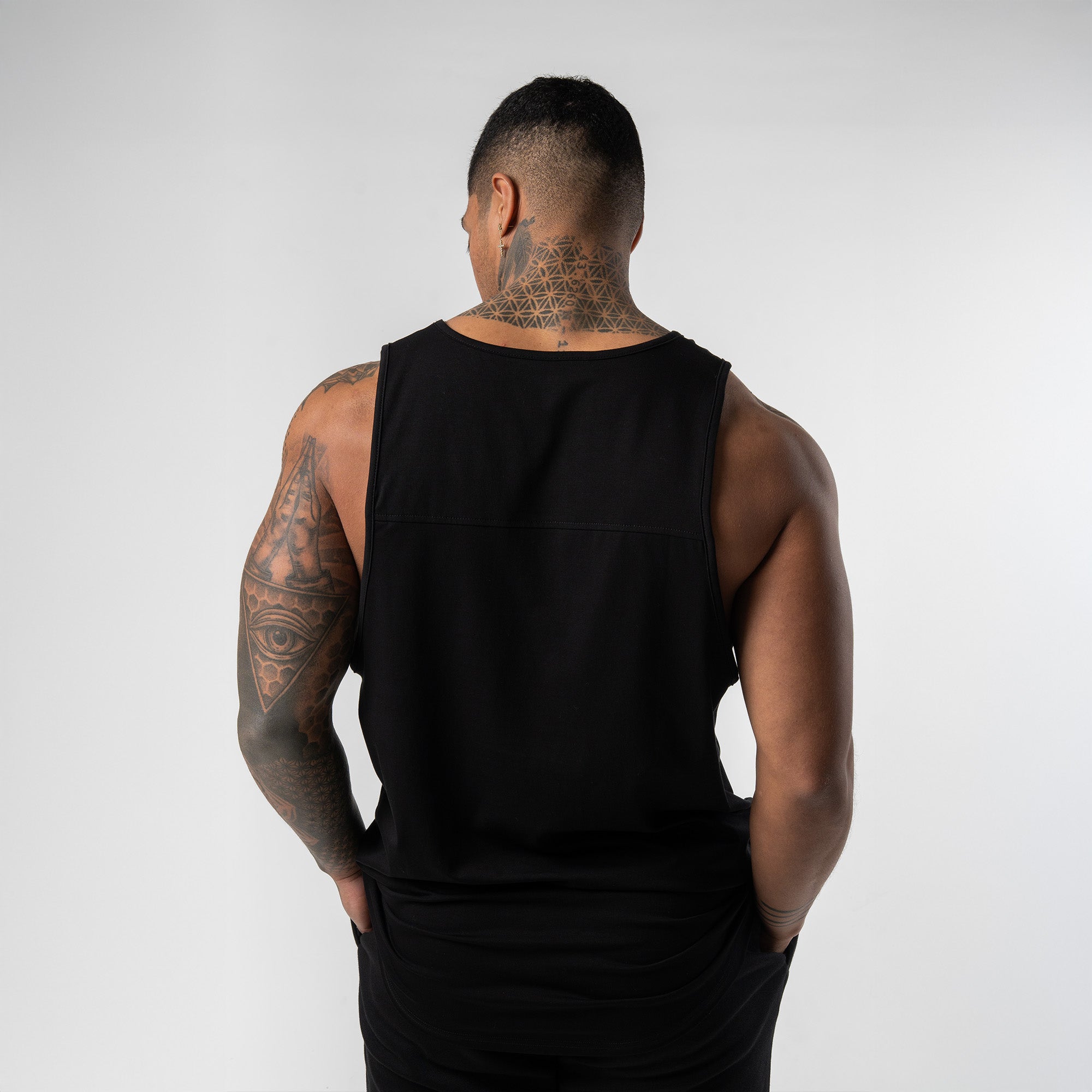 Athlete wearing black axis scoop hem tank back view