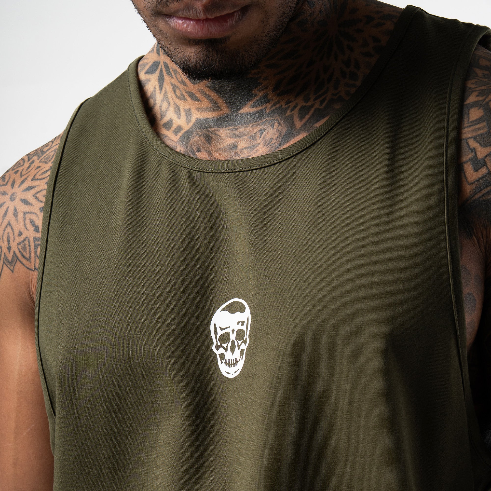 athlete wearing green axis scoop hem tank close up shot of logo