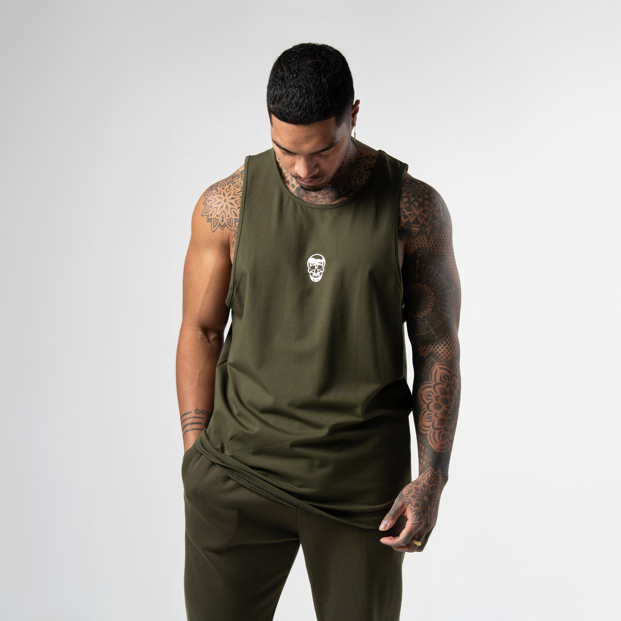 athlete wearing green axis scoop hem tank front view