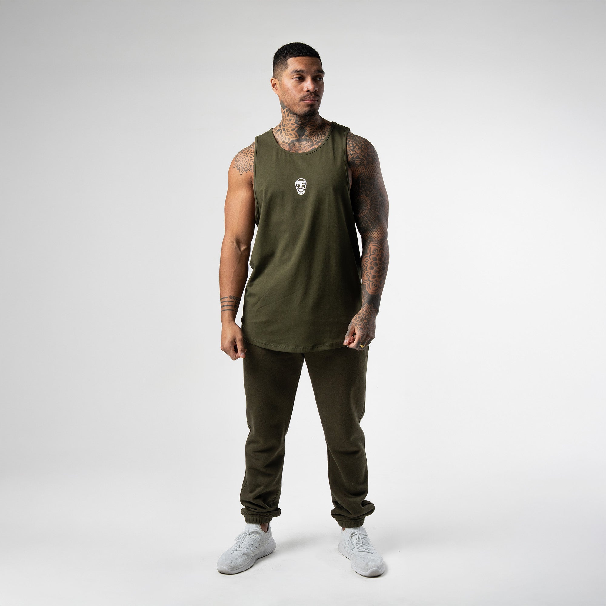 athlete wearing green axis scoop hem tank full body shot