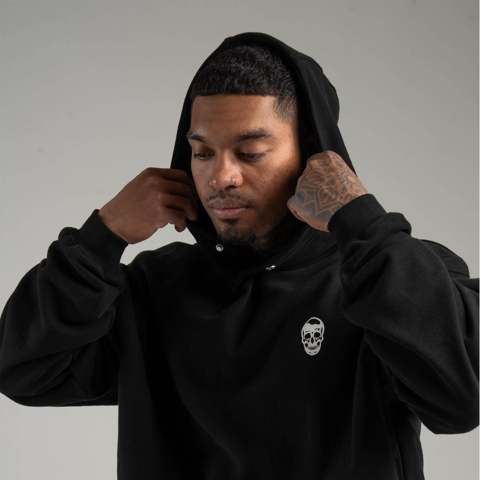 athlete wearing Black Heavyweight Hoodie with hood on