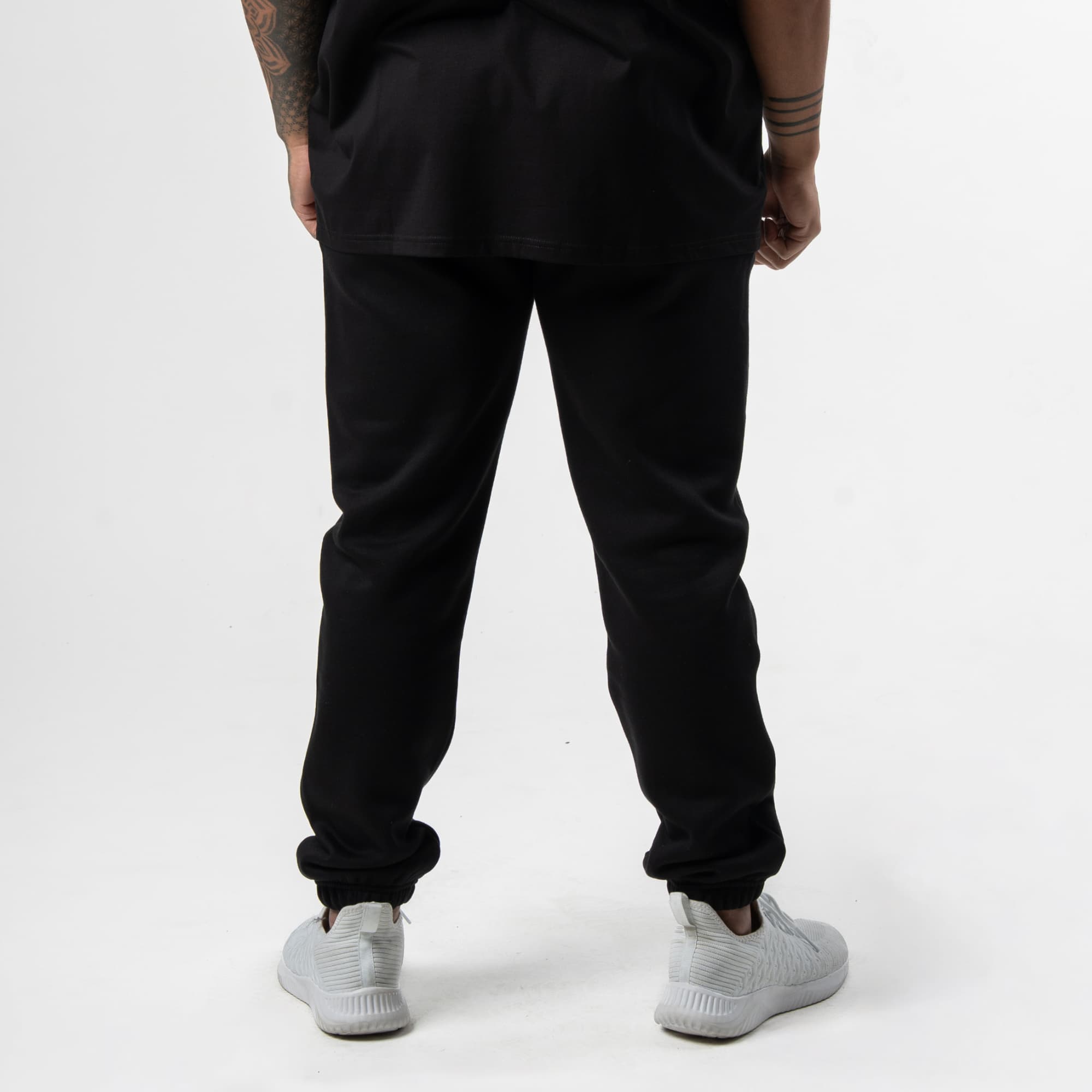 athlete wearing black/white axis joggers back view