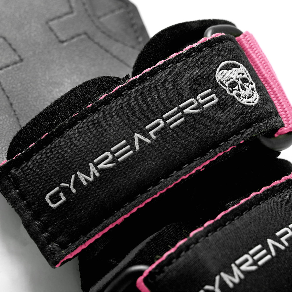 macro zoom of the Gymreapers logo on pink weightlifting grips