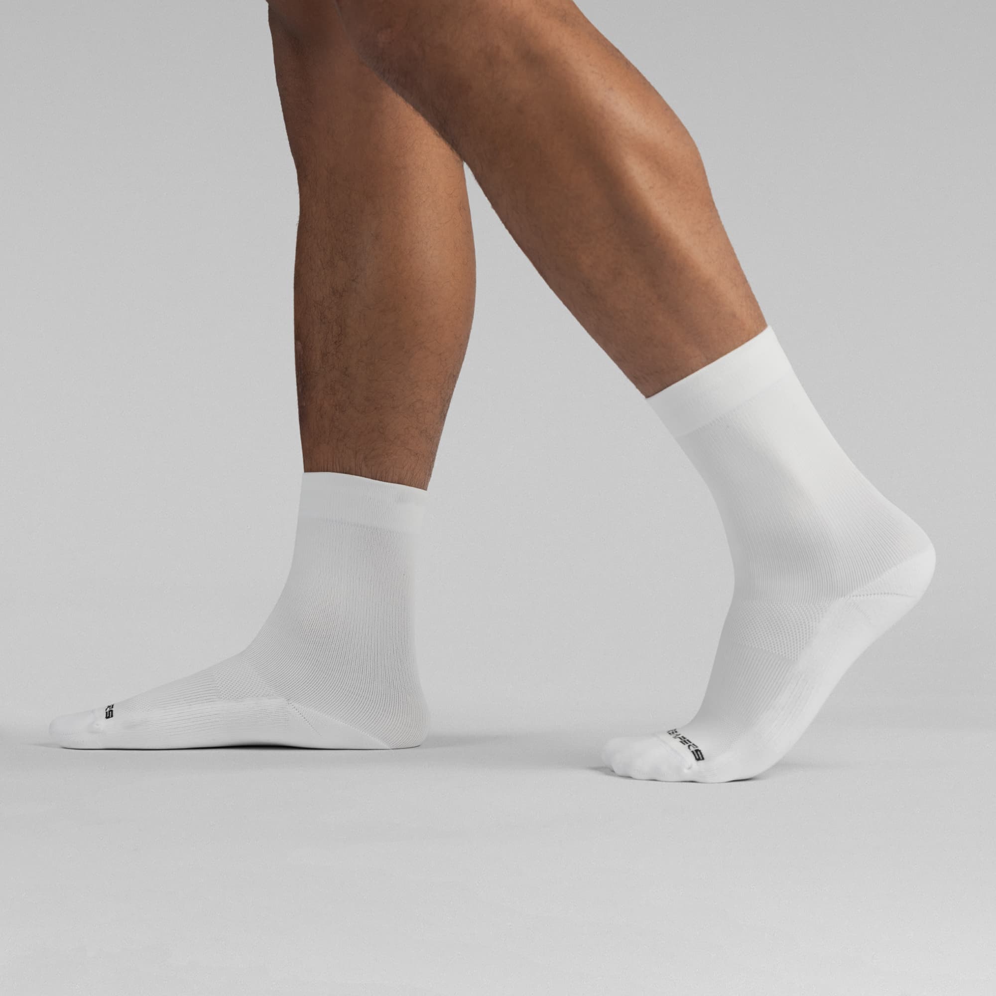 Athlete wearing the White Stryda™ Crew Run Socks side view