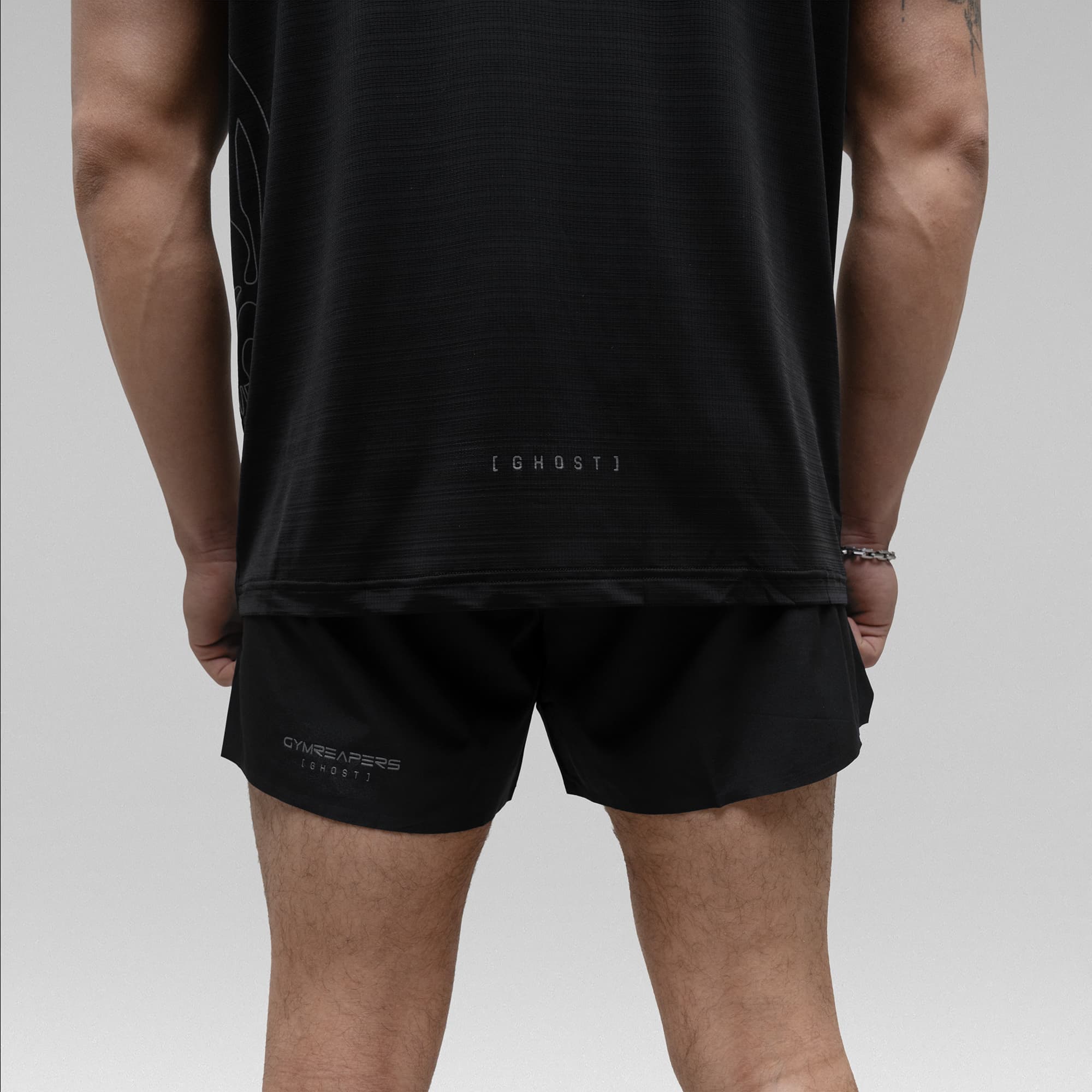 Athlete wearing the Ghost 5" Run Shorts half body shot back view
