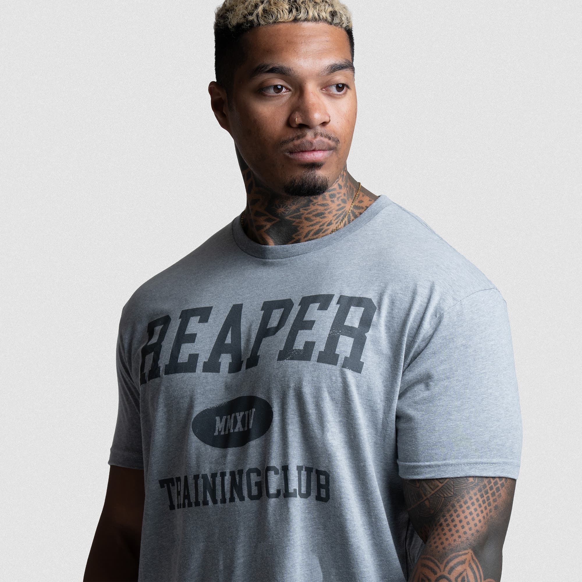 Side angle of Reaper Training Club Tee in gray, showcasing relaxed fit and front graphic design.