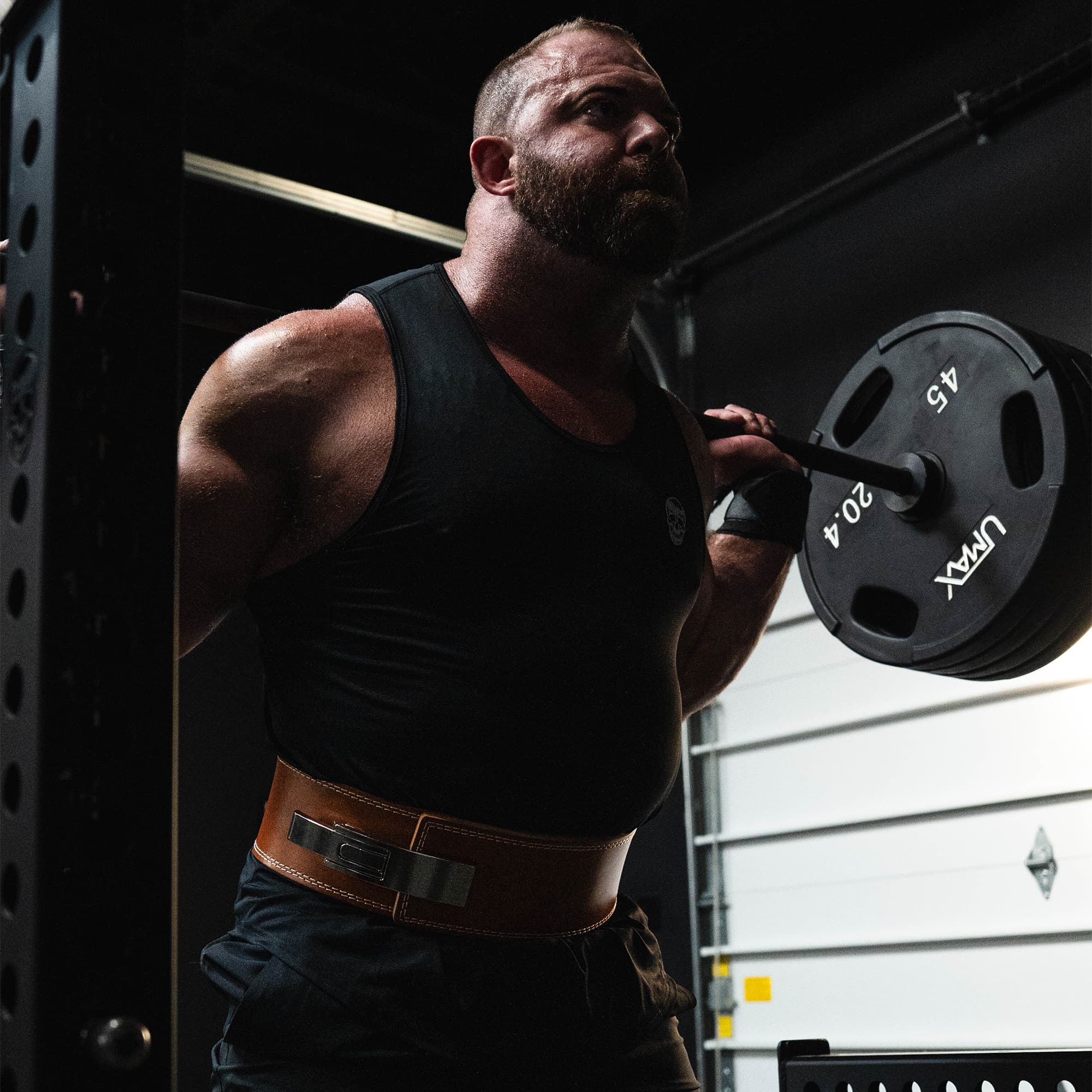 Athlete squatting while wearing the heritage lever belt