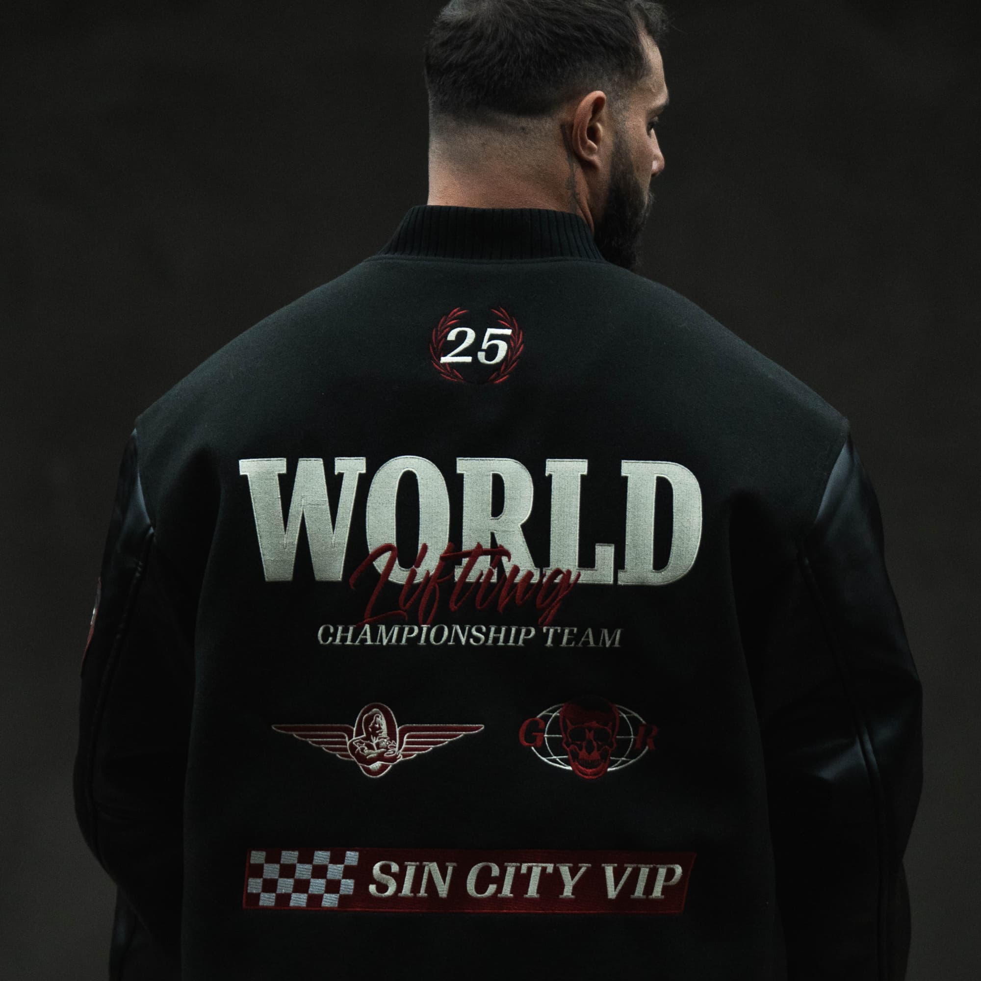 Model wearing the Racing Team Varsity Jacket showing the large back graphics.