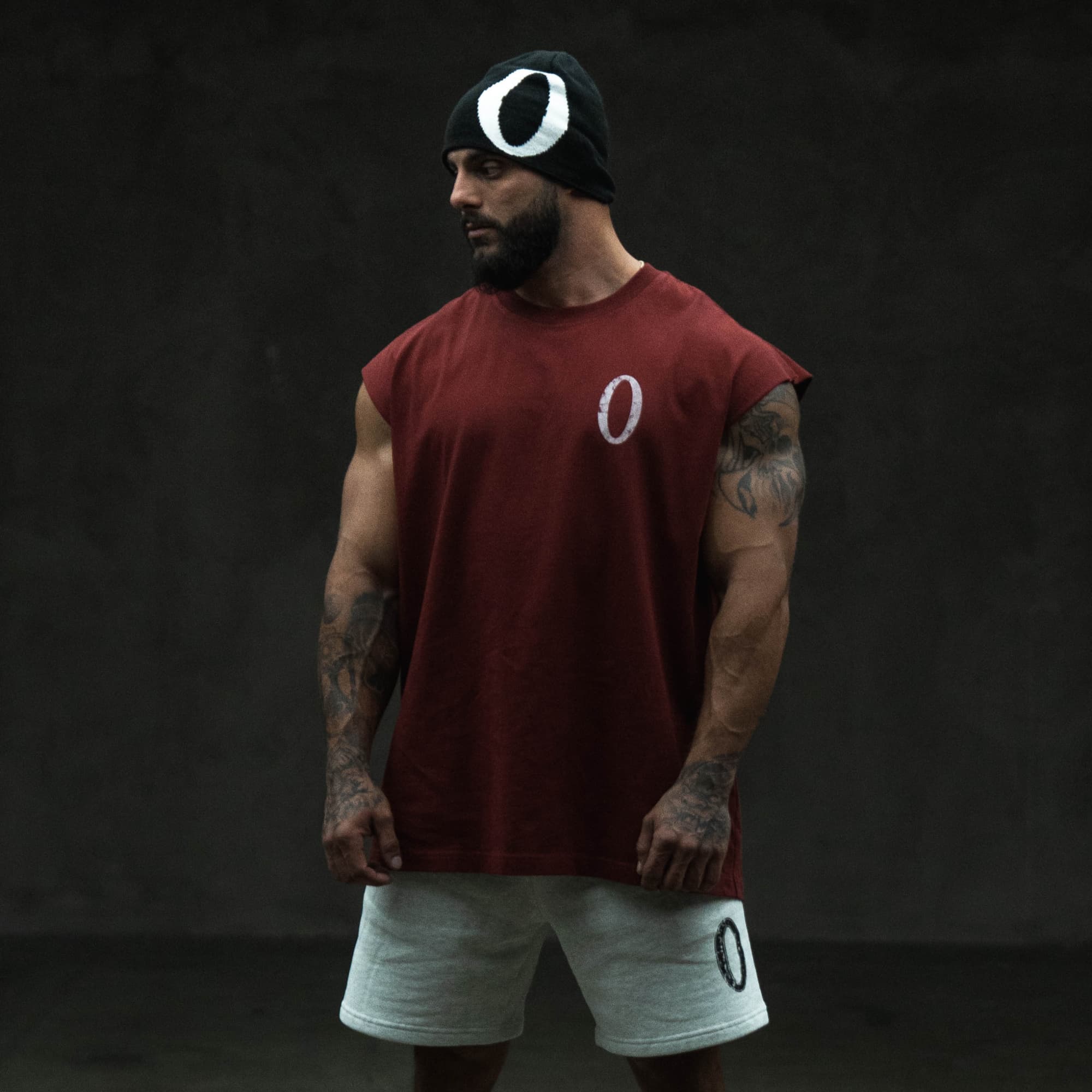athlete wearing the olympia cut off showing front chest graphic