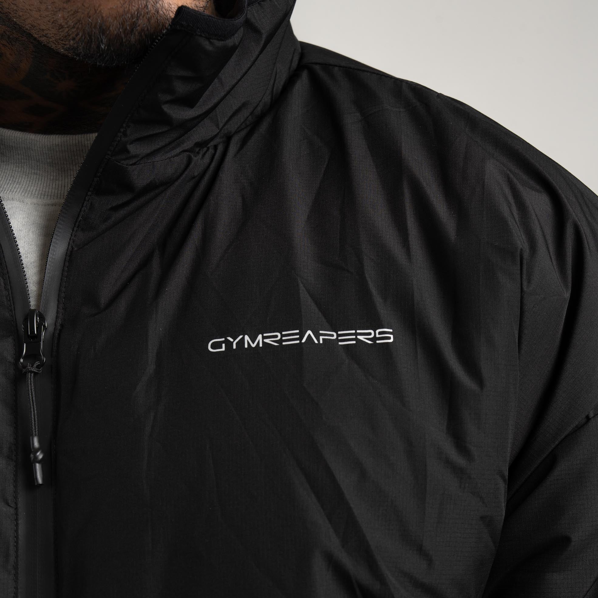 athlete wearing the Arktik Puffer Jacket close up shot of front logo