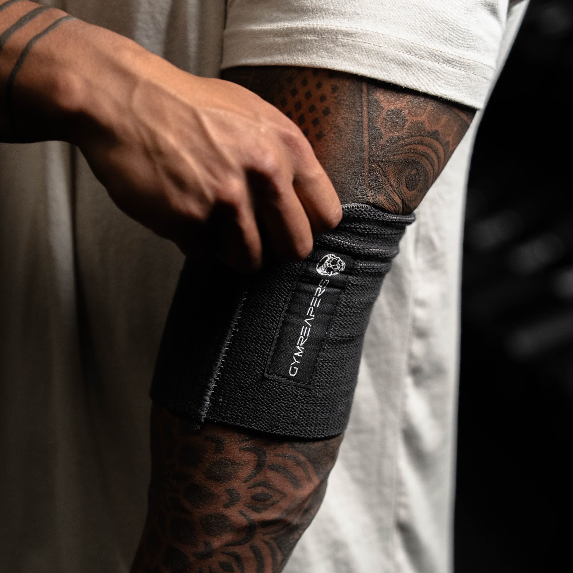 athlete putting on an elbow compression cuff