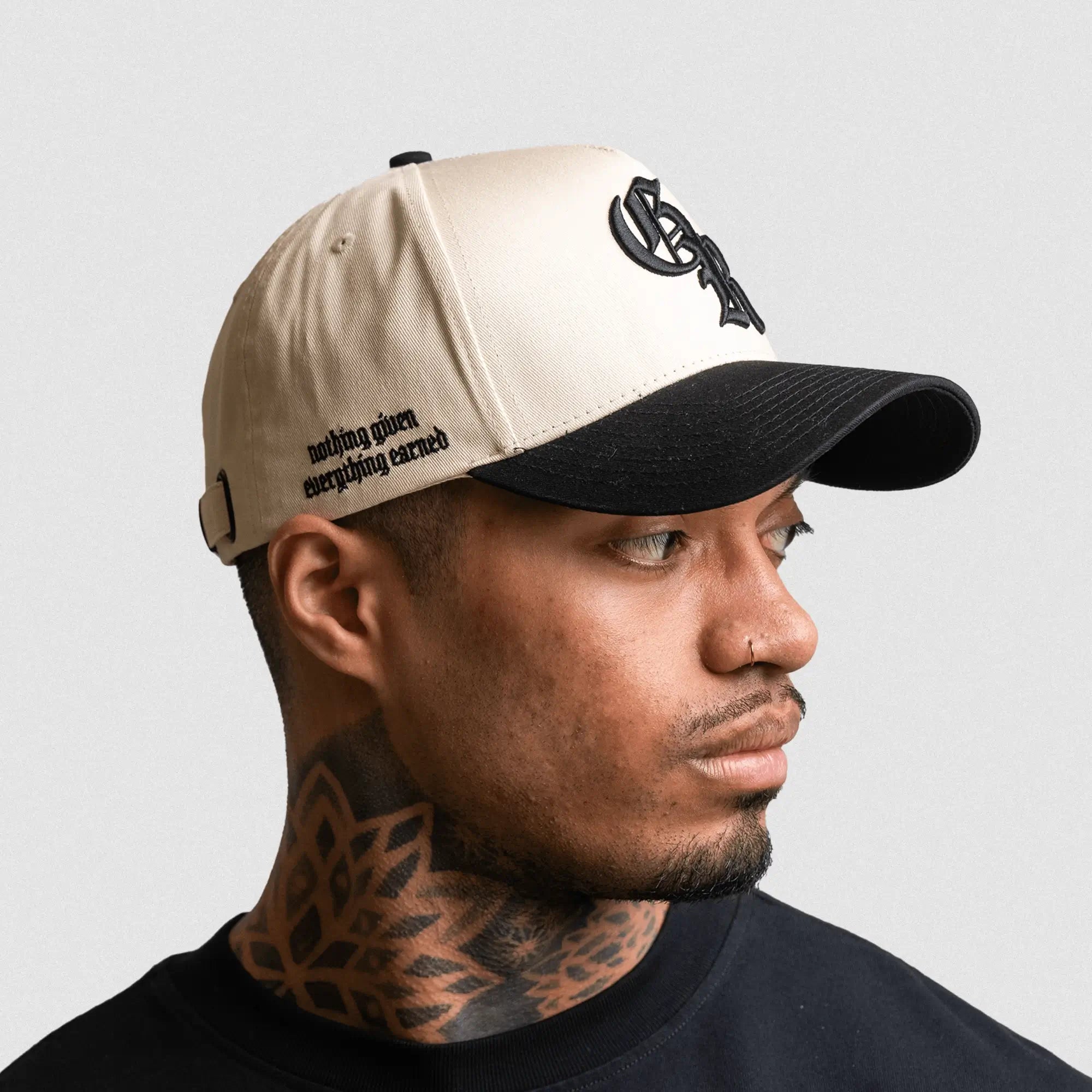 5 panel initial hat cream black on athlete studio gray background right side with Gymreapers mantra 