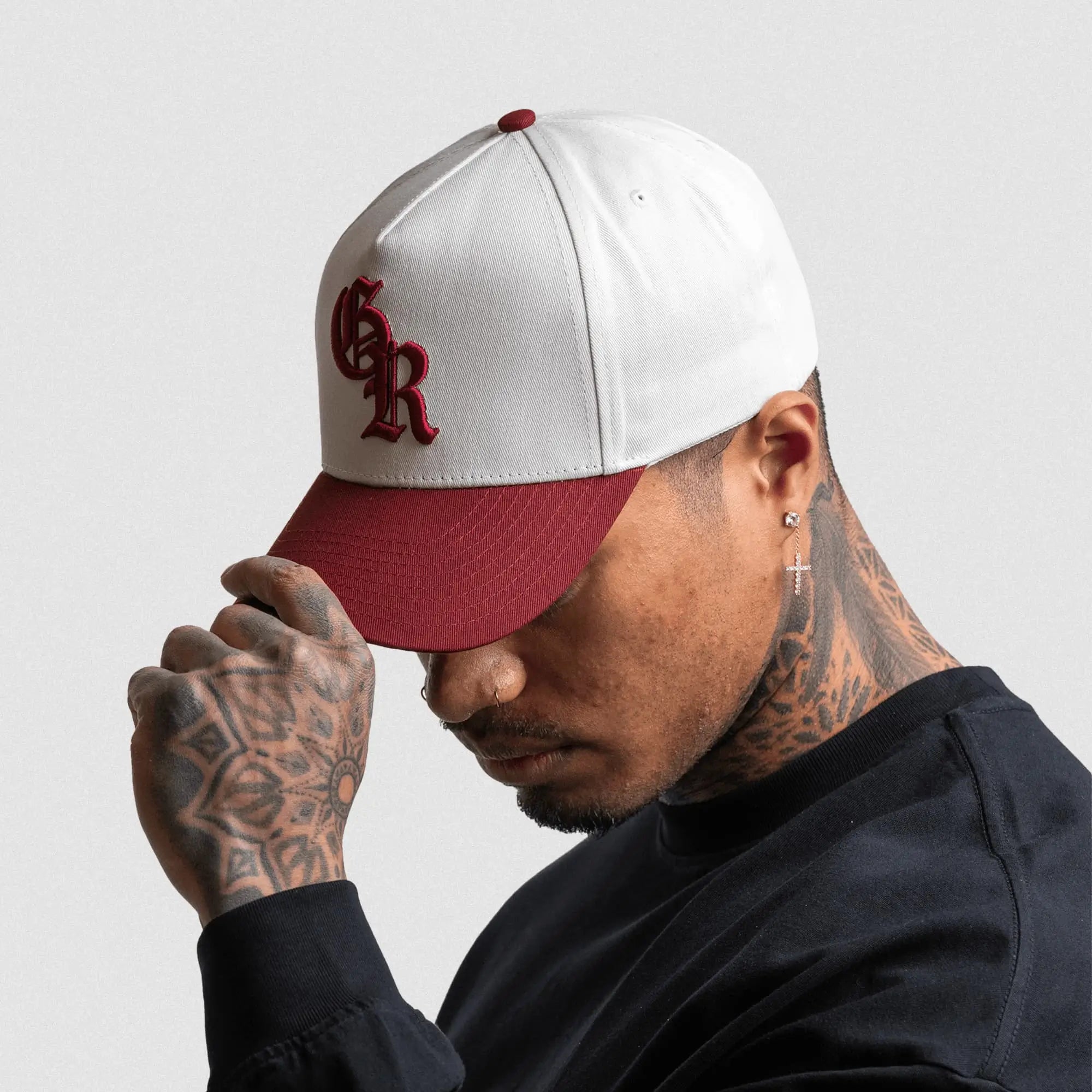 5 panel initial hat white maroon side view on athlete gray background