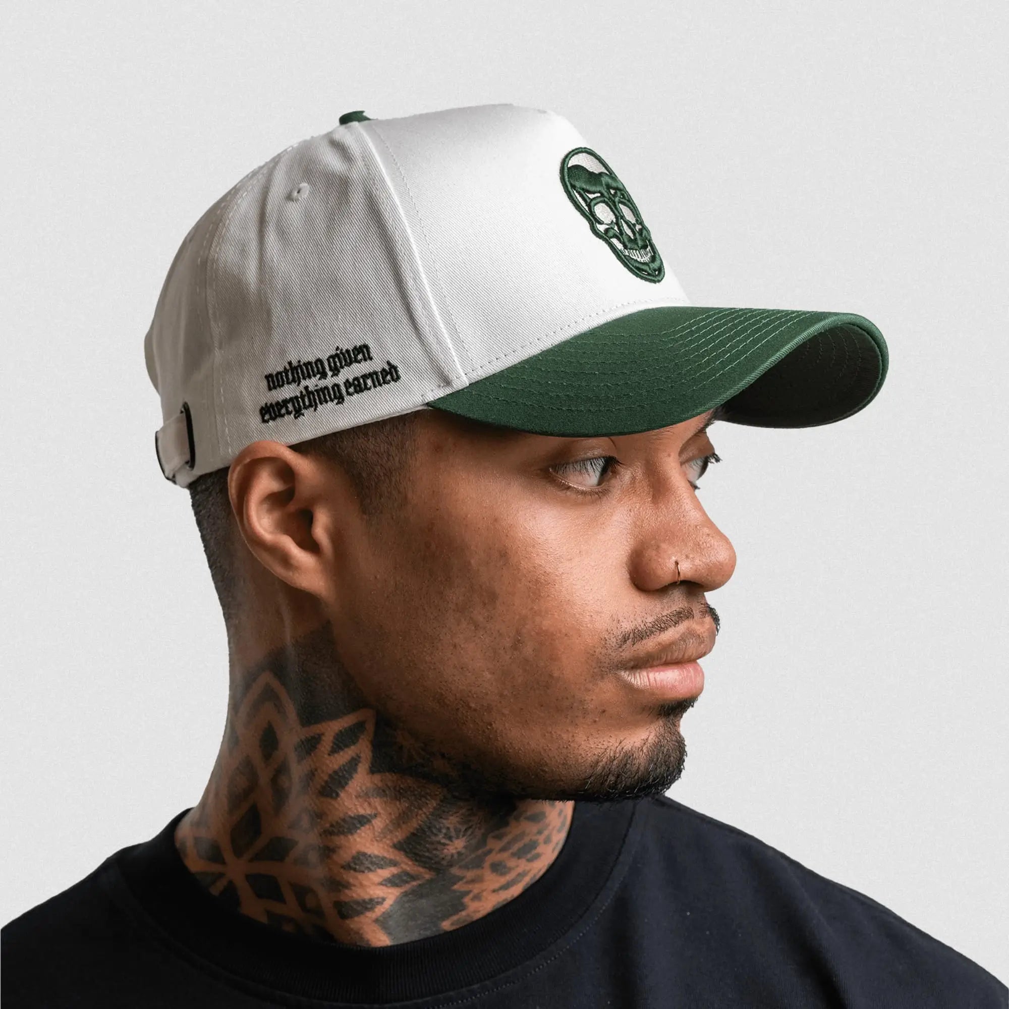 5 panel skull hat white green mantra on athlete side view gray background