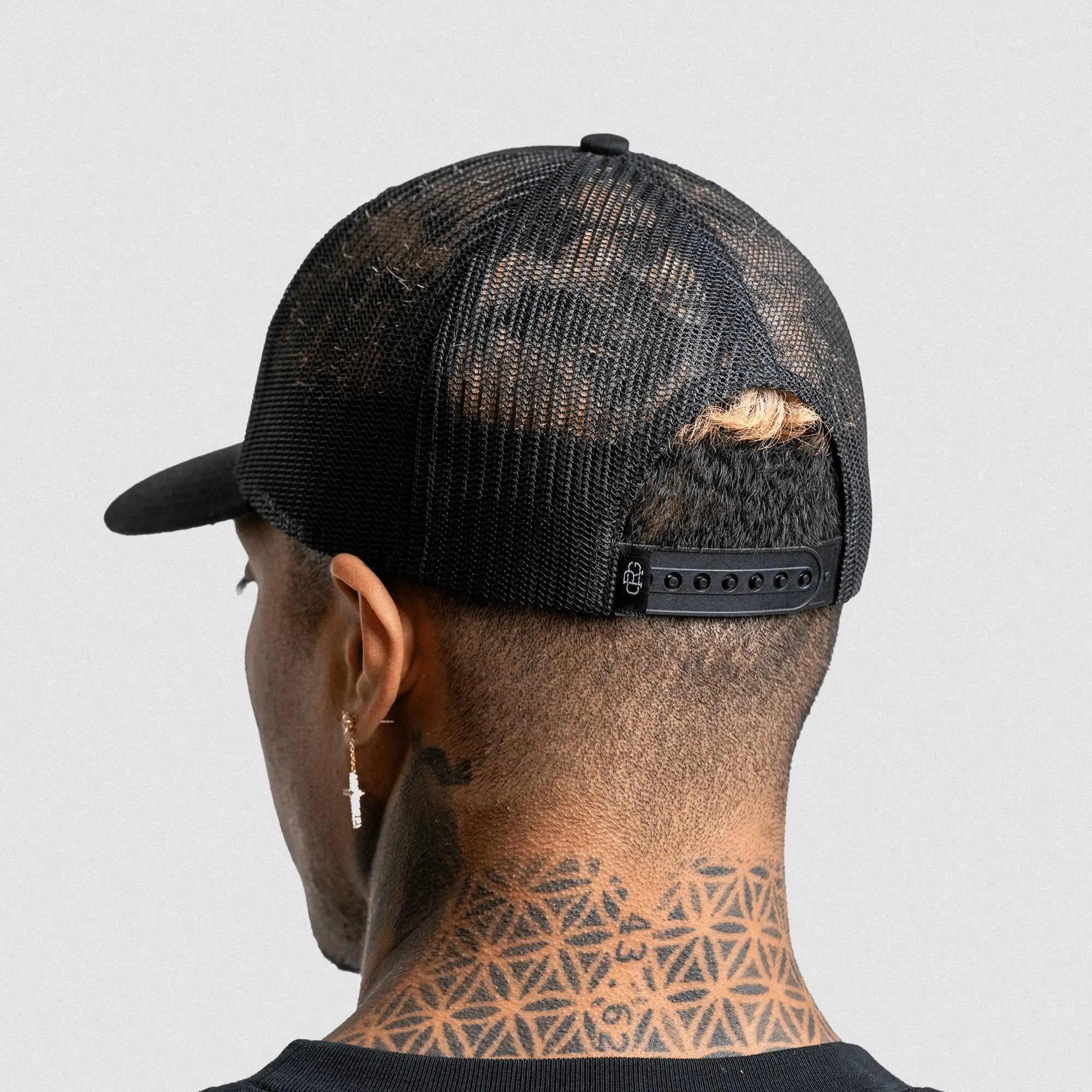 6 panel hat black black on athlete studio gray background. Back shot