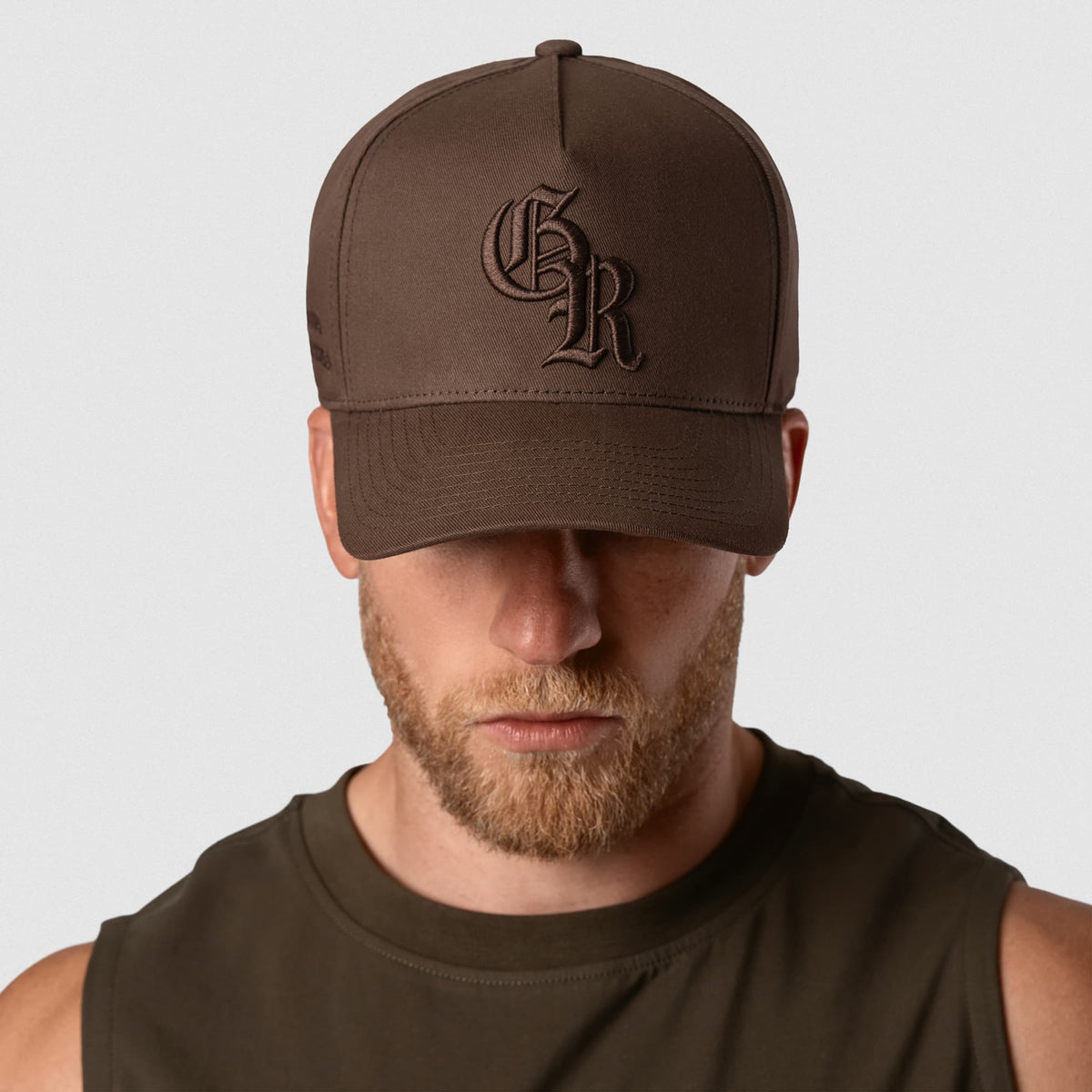 Male model wearing the 5-Panel Initial Hat - Brown front view