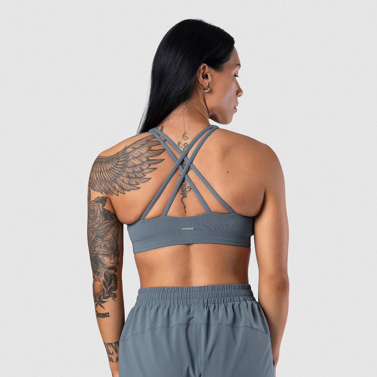 Female model wearing the Axis High Neck Bra - Lake back view