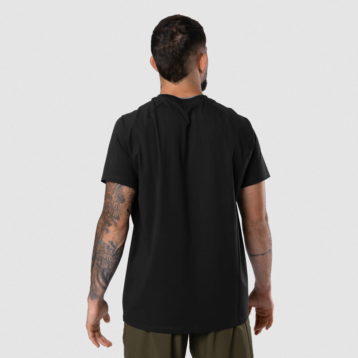 Male model wearing the Axis Raglan Tee - Black/Black back view