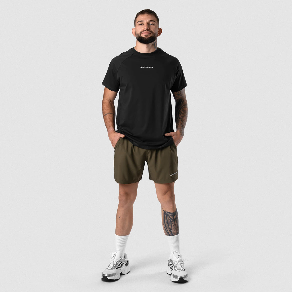 Male model wearing the Axis Raglan Tee - Black/White full-body view