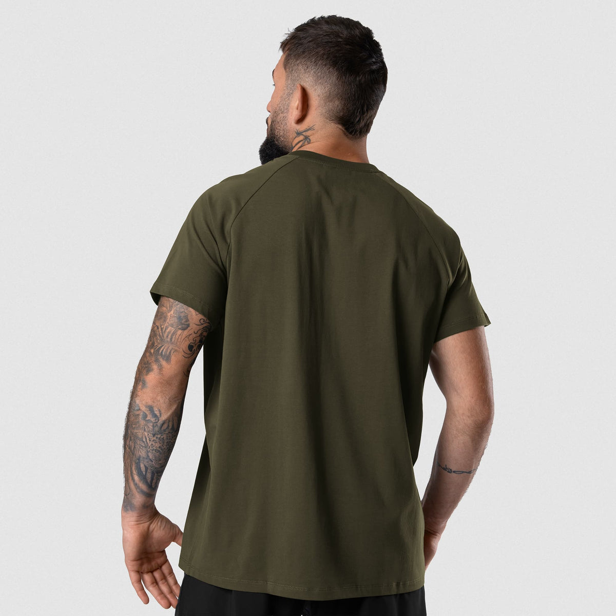 Male model wearing the Axis Raglan Tee - OD Green back view