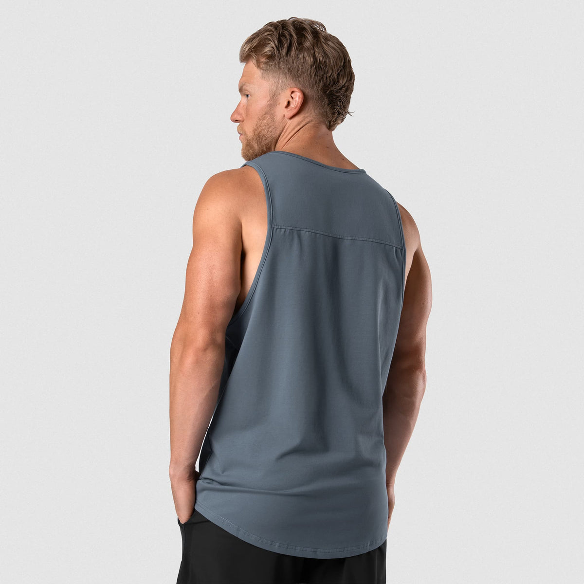 Male model wearing the Axis Scoop Hem Tank - Lake back view
