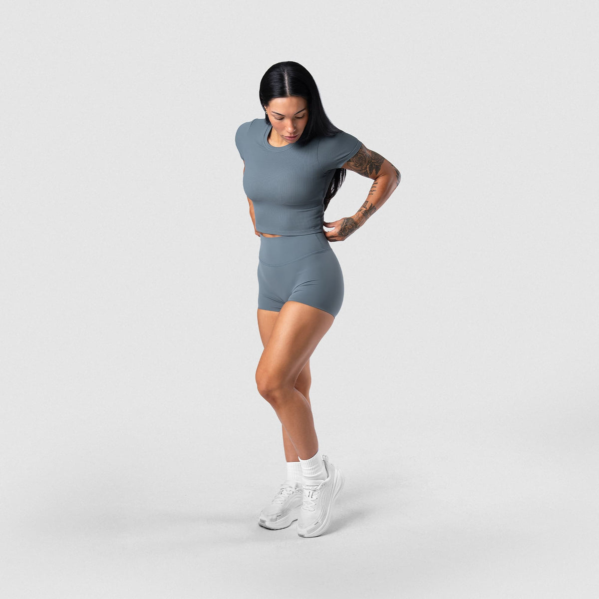Female model wearing the Axis 4" Shorts - Lake full-body view