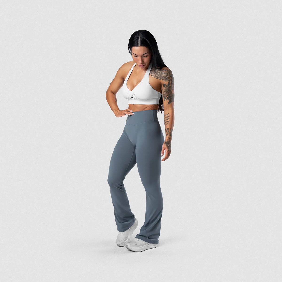 Female model wearing the Axis Twisted Halter Bra - White full-body view