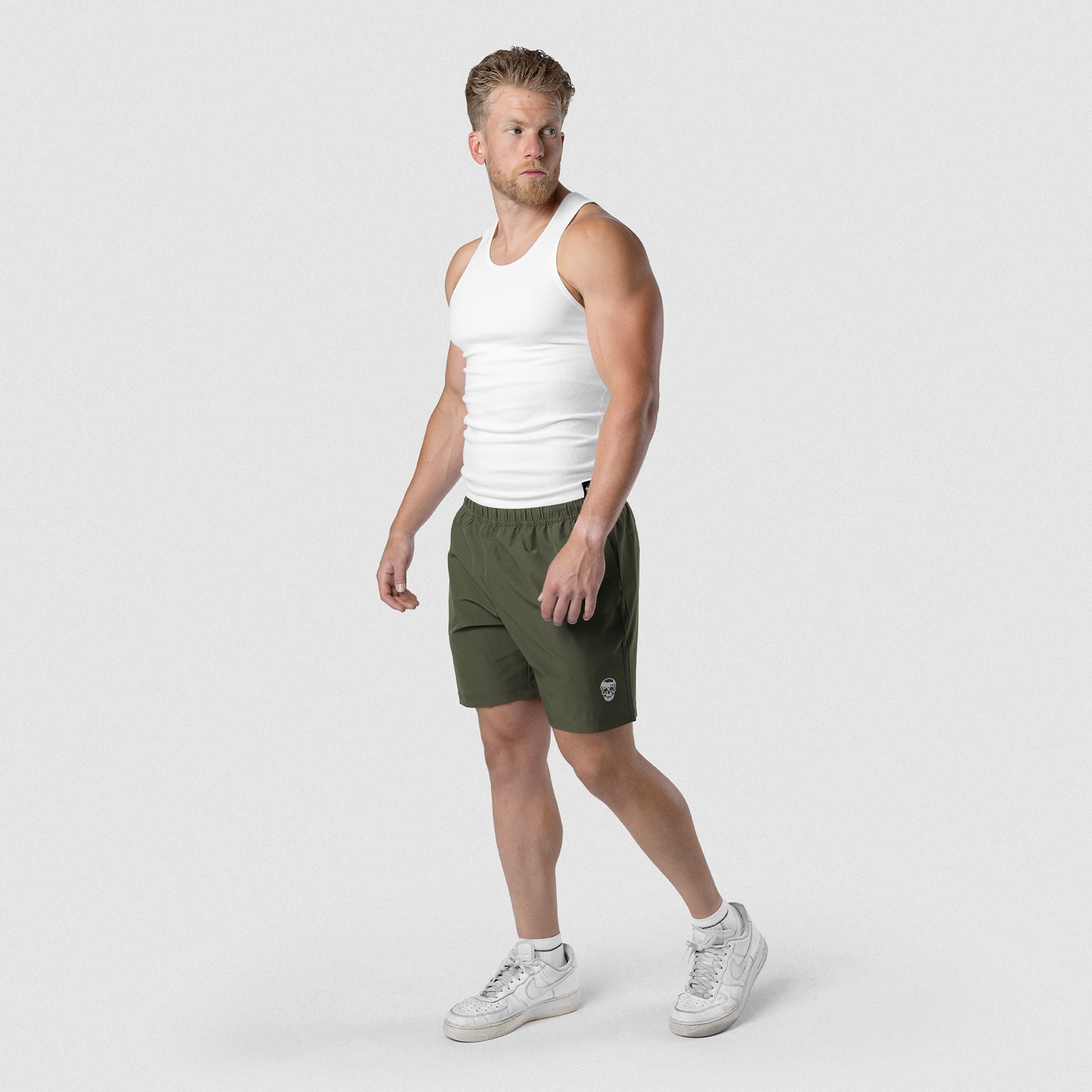 Model wearing Men's Conquer 7 Inch Shorts - OD Green