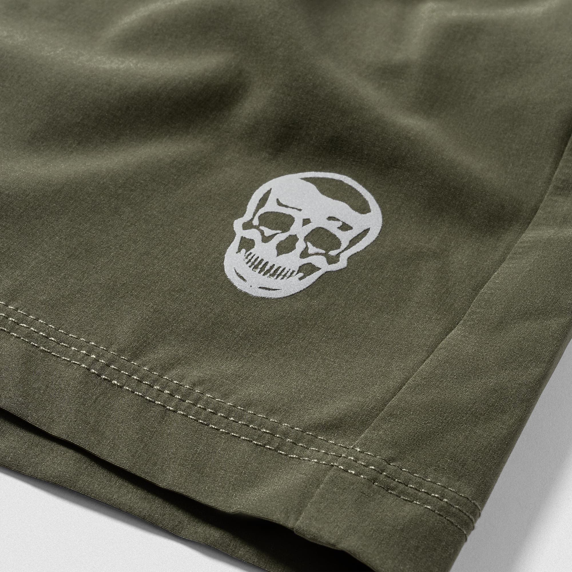 Reflective Gymreapers skull logo detail on Men's Conquer 7 Inch Shorts - OD Green