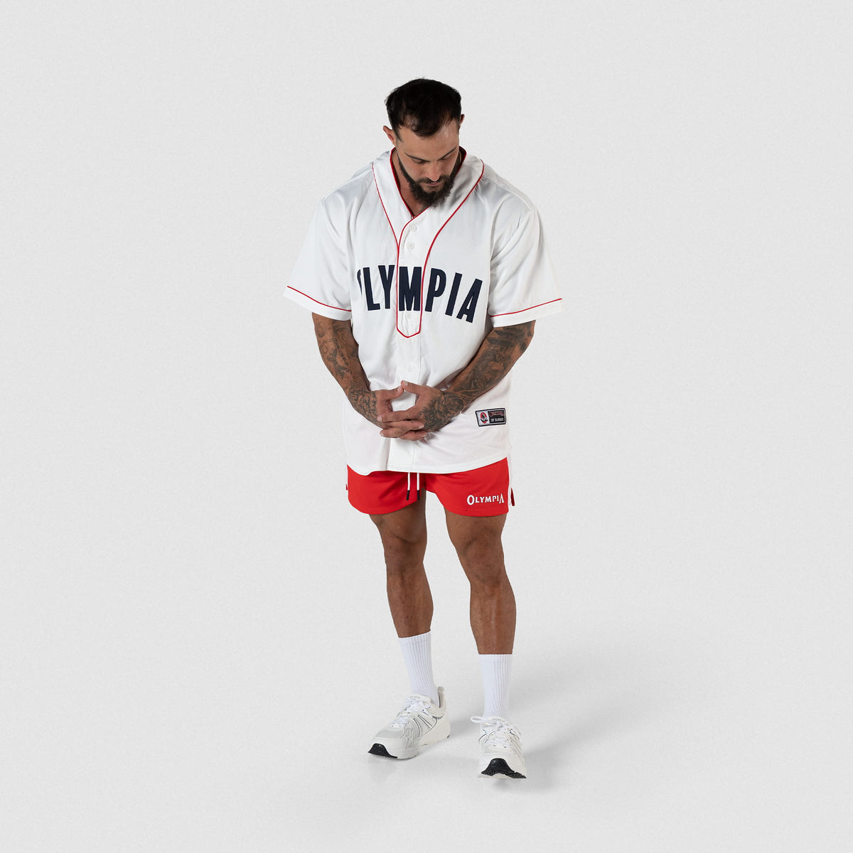 Olympia Americana Jersey | Full body, front facing view of male model wearing jersey with red shorts