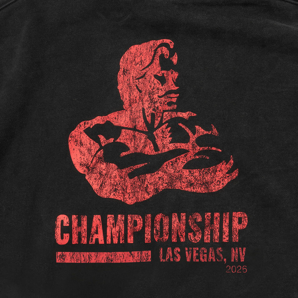 Championship Crop Hoodie | Close up feature of back logo of red Championship Las Vegas NV 2026 Olympia event logo on black fabric