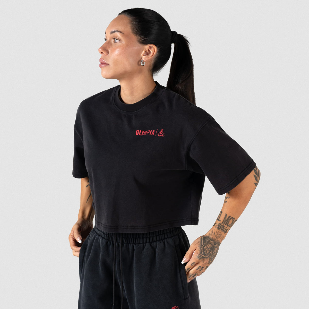 Front view of female model wearing the women's black Championship Crop Tee