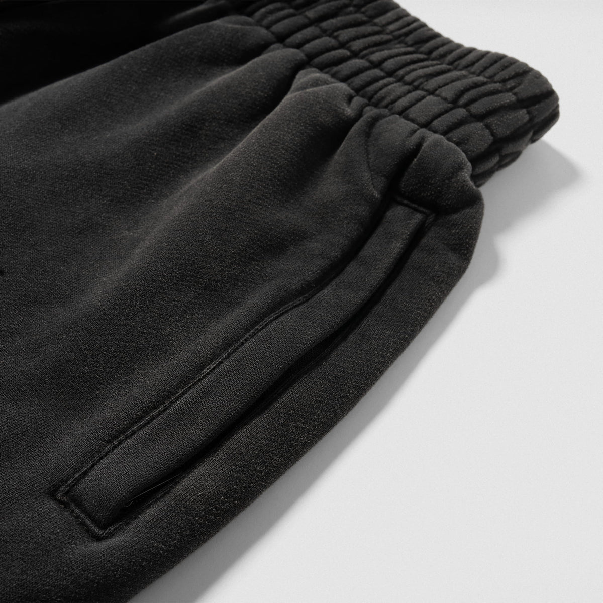 Close up of the pocket and adjustable waistband found on the black Championship Wide-Leg Jogger