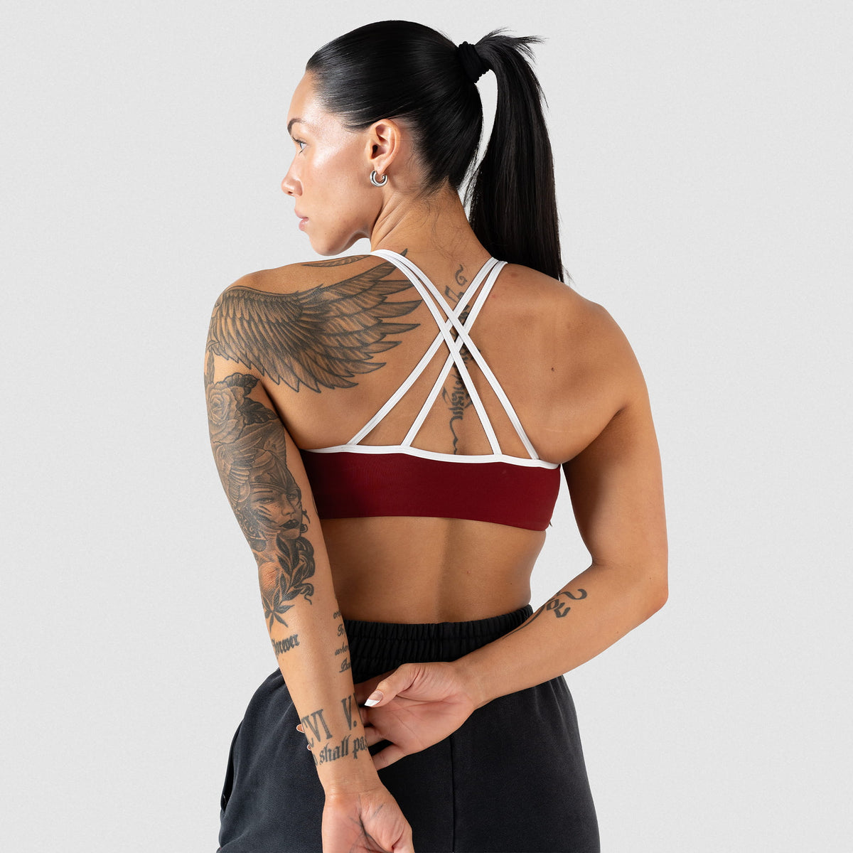 Back of the High Neck Olympia sports bra that shows the white straps and contrasting red body of the bra