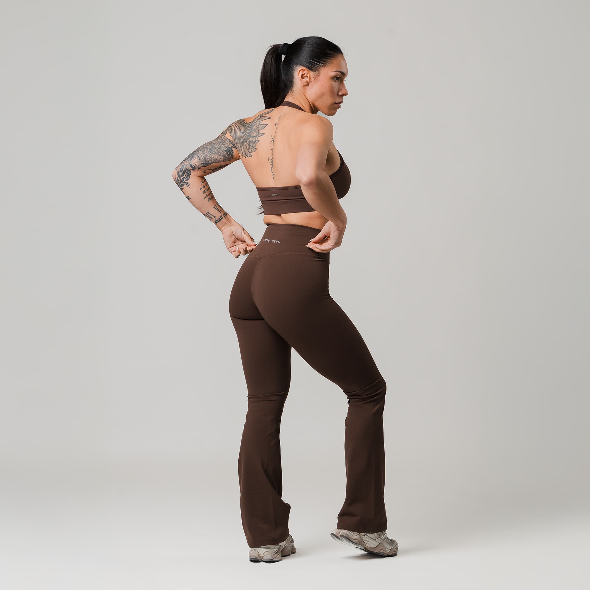 athlete wearing brown axis flare leggings full body shot back view