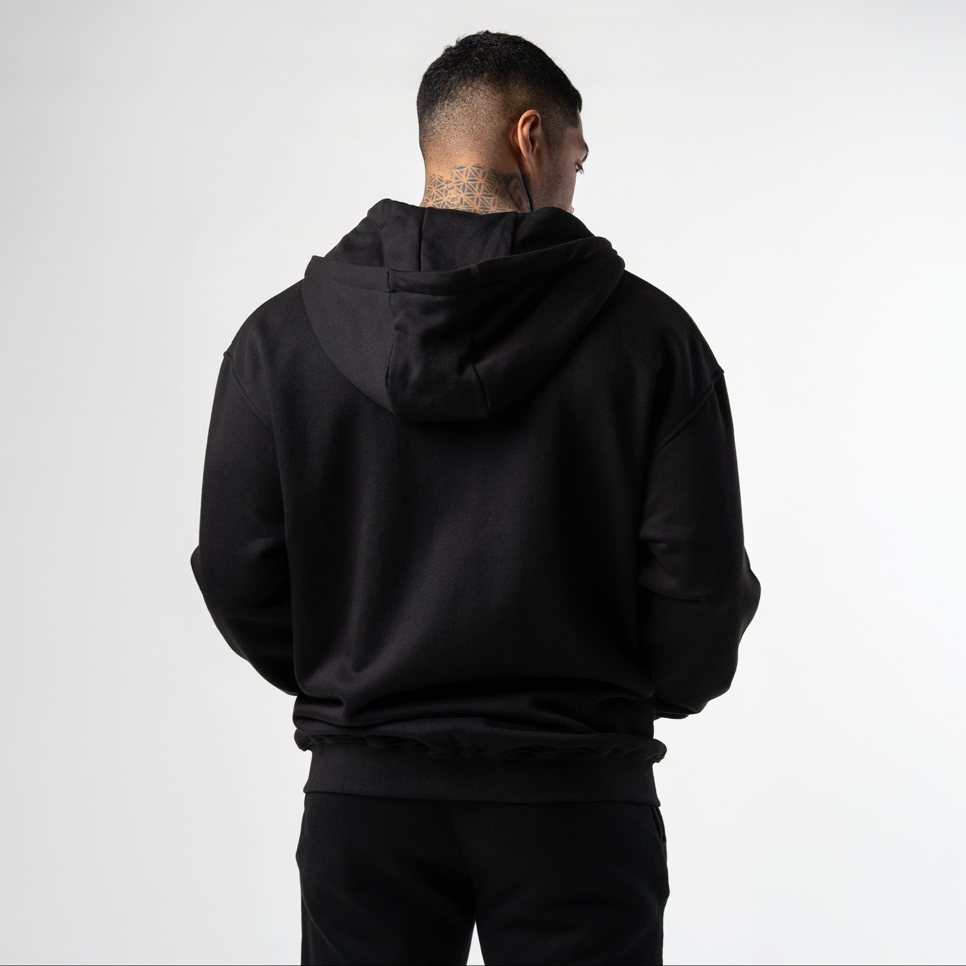 athlete wearing black/white axis zip up back view