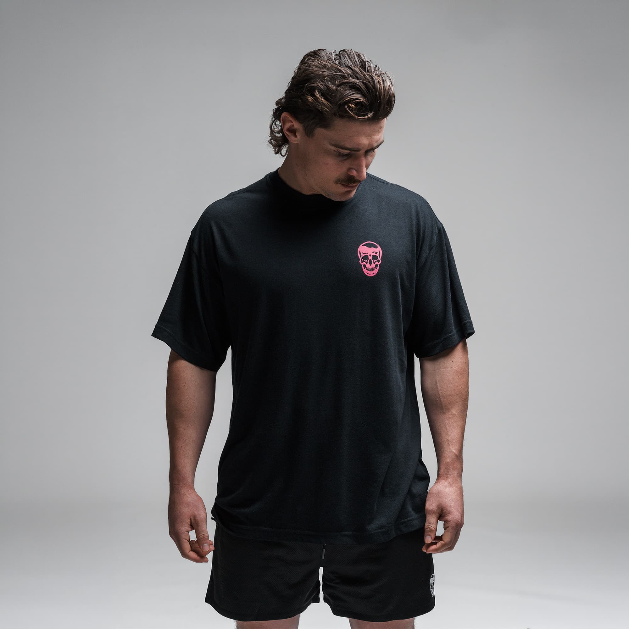 Athlete wearing the Miami Training Club Tee half body shot front view