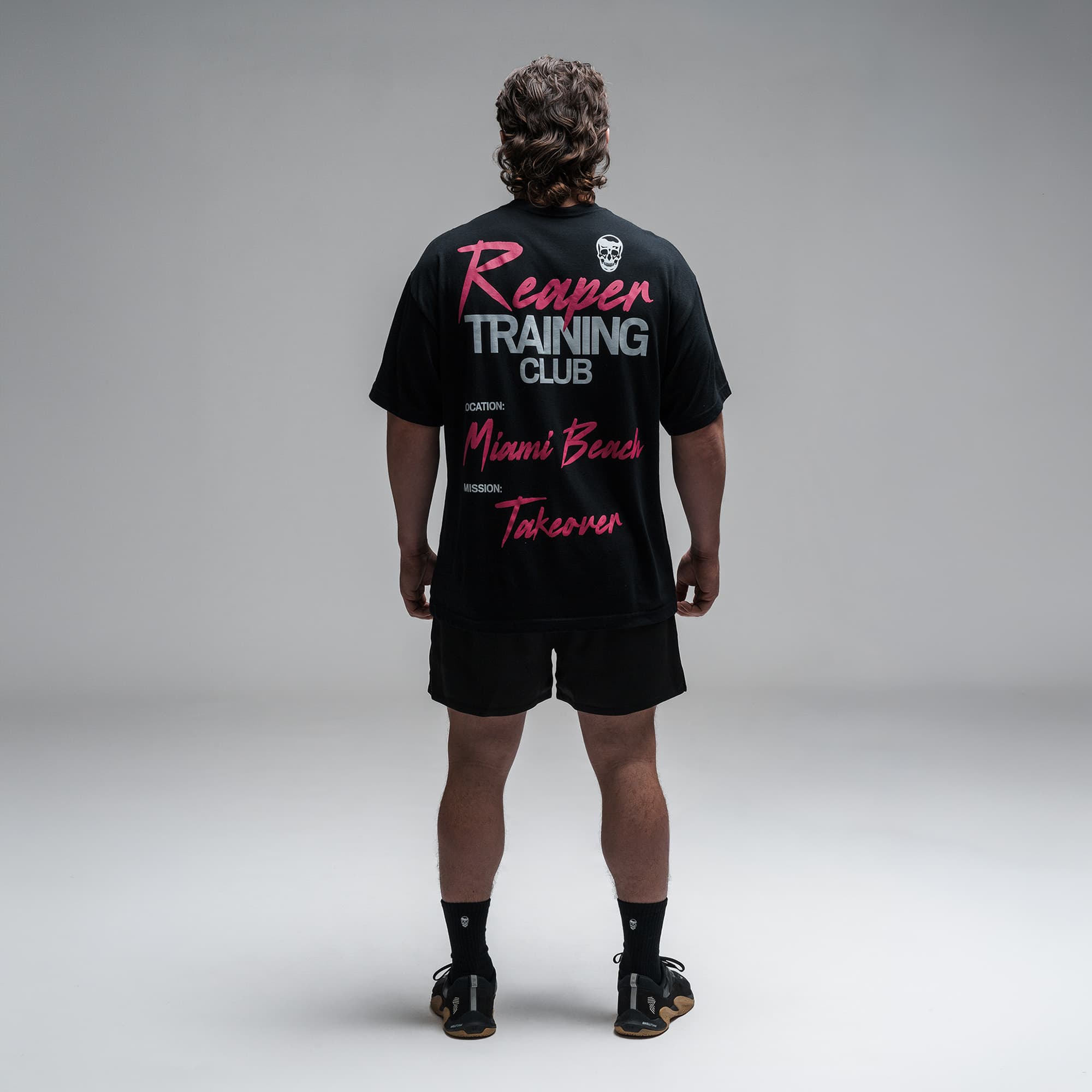 Athlete wearing the Miami Training Club Tee full body shot back view