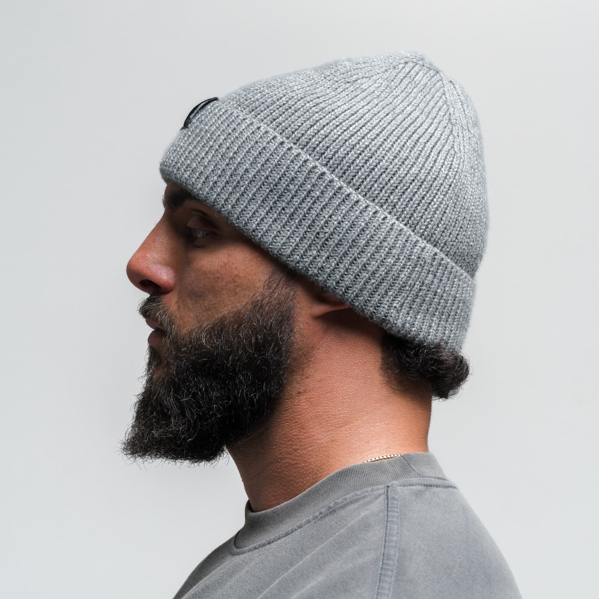 Athlete wearing Ribbed Knit Skull Beanie - Dark Gray side view